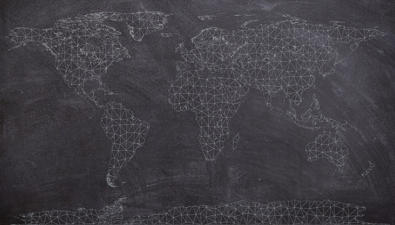Geometric world map on a chalkboard background symbolizing global connections and market expansion.